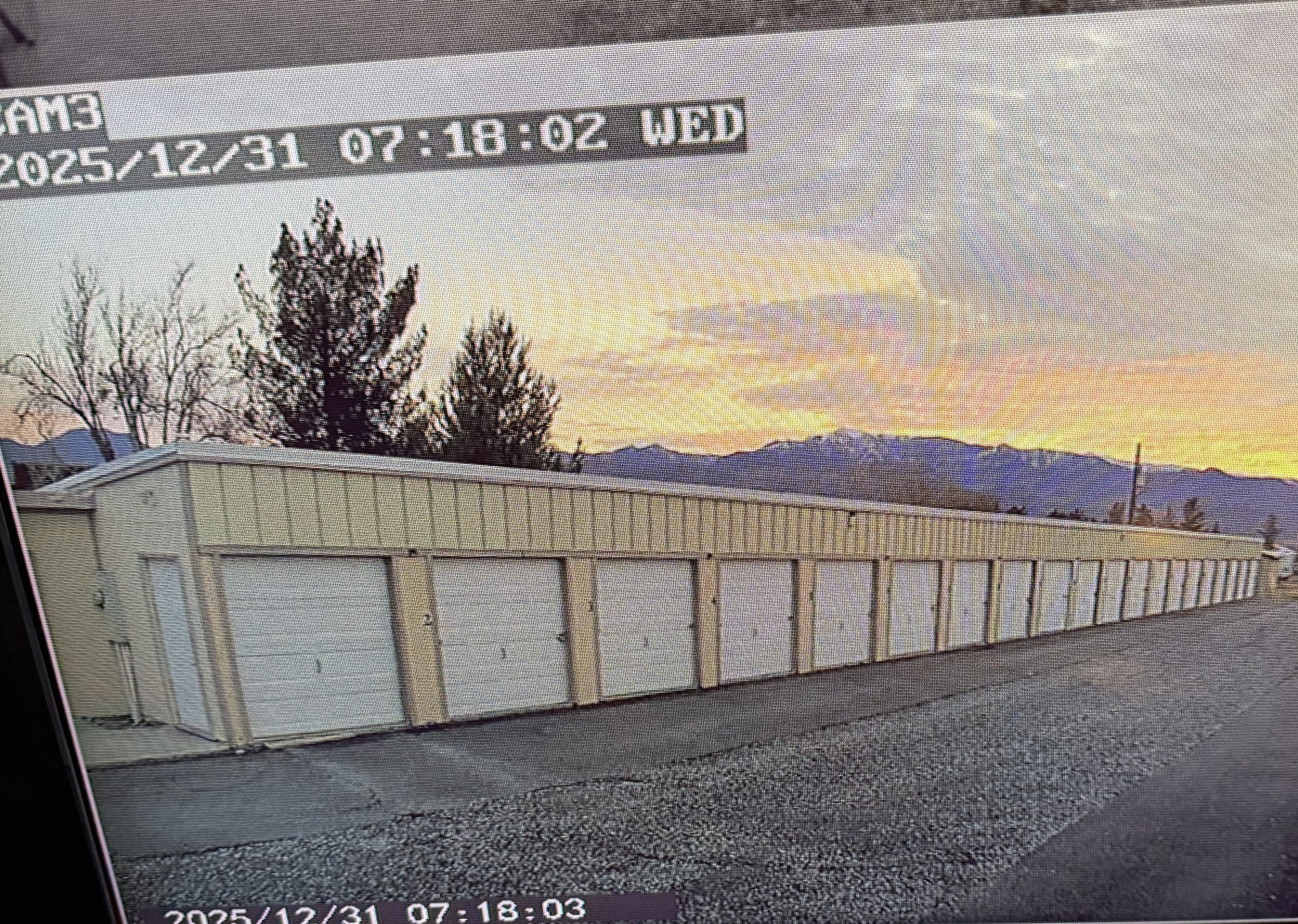 A live camera view of the storage lane at sunrise on the monitor inside the Decroff Storage office.